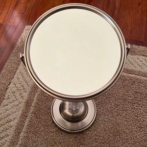2 sided Stand mirror with additional magnifier.
